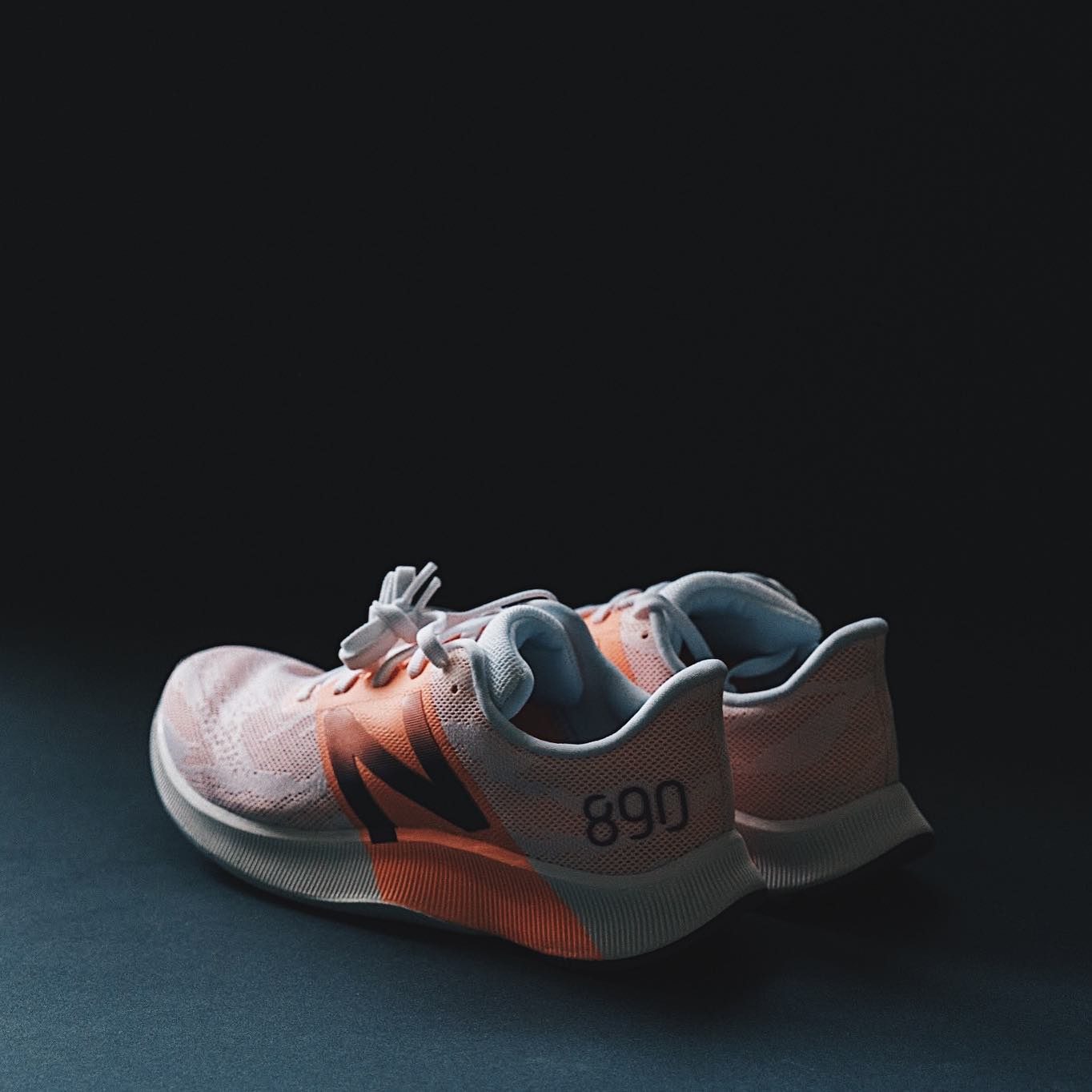 Pink New Balance 890 floating product shot