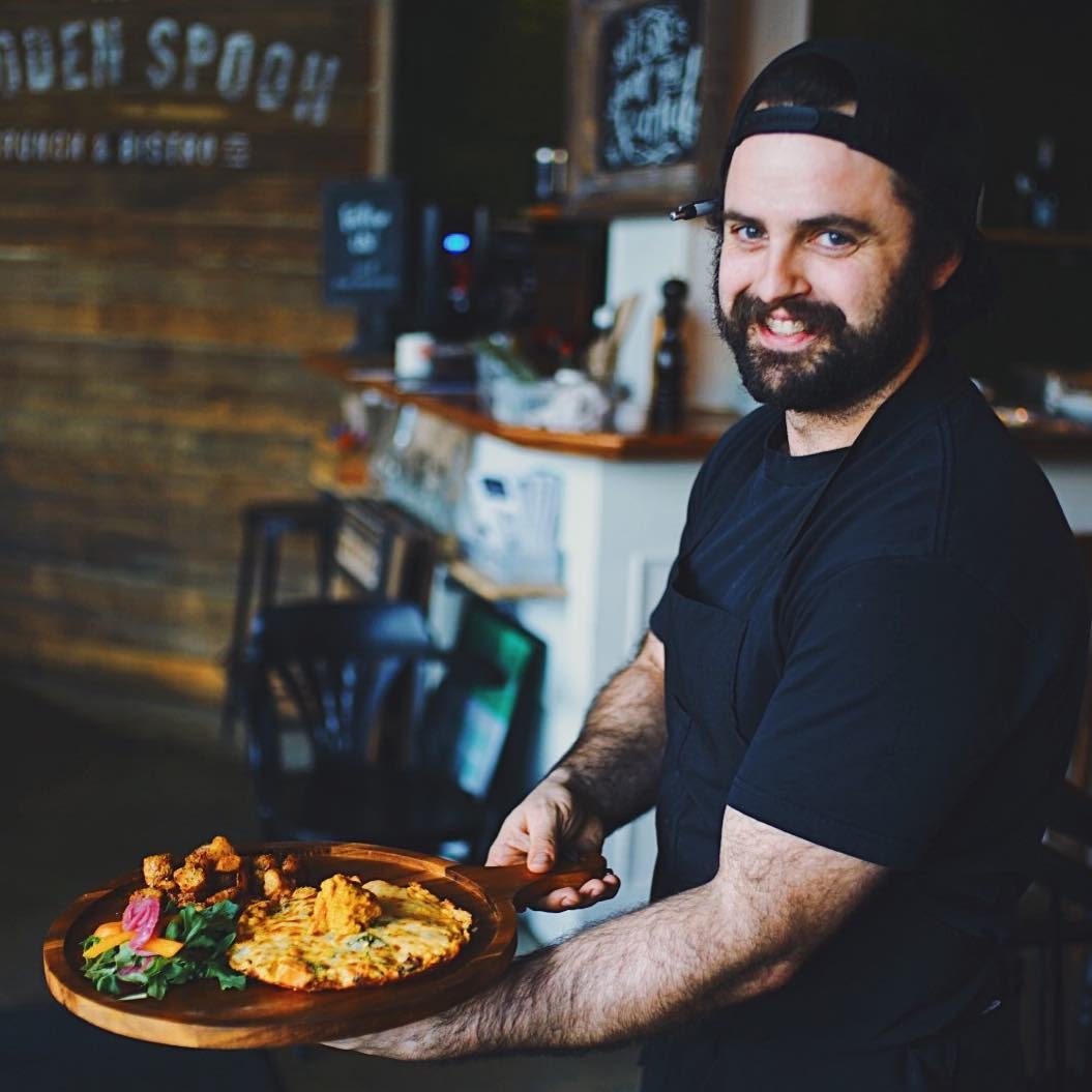 Barista serving a plated dish